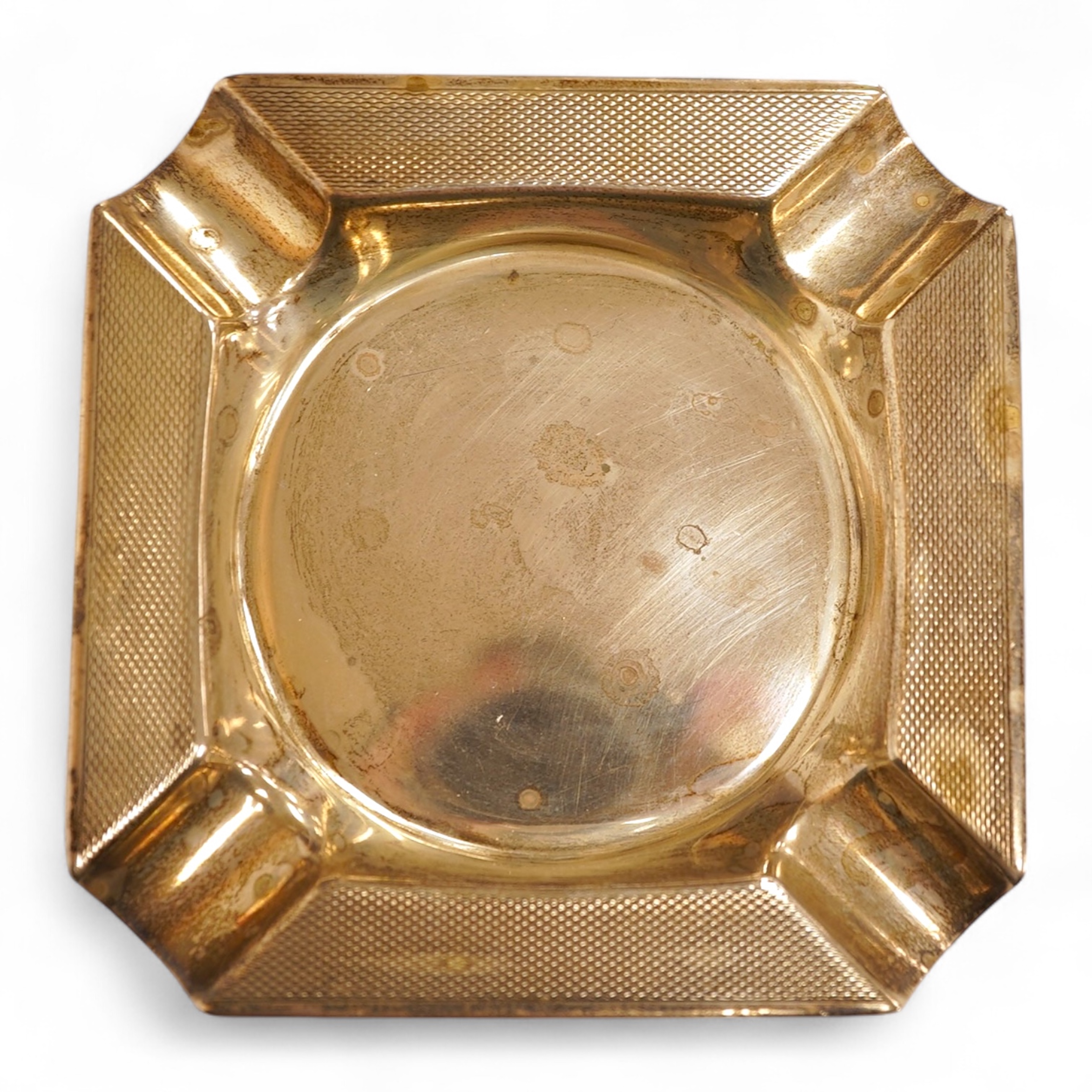 A heavy square engine-turned silver ashtray, by Mappin & Webb, Sheffield, 1964, 99mm, 6oz.